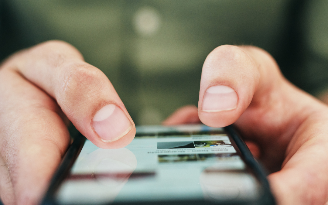 A photo of someone holding a cell phone and posting something online.